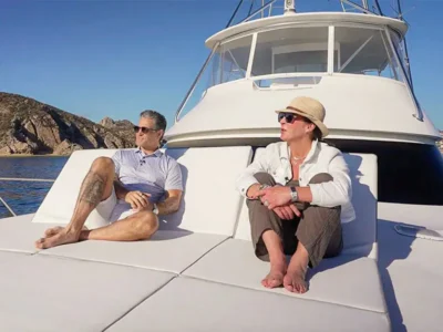 Ian Gengos and a Realm Global representative enjoying a private yacht experience in Los Cabos, reflecting the luxury lifestyle featured in Realm’s Location Luxe article